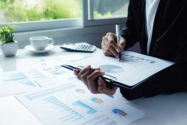 case interview profitability framework. The image shows a business woman reading a pie chart.
