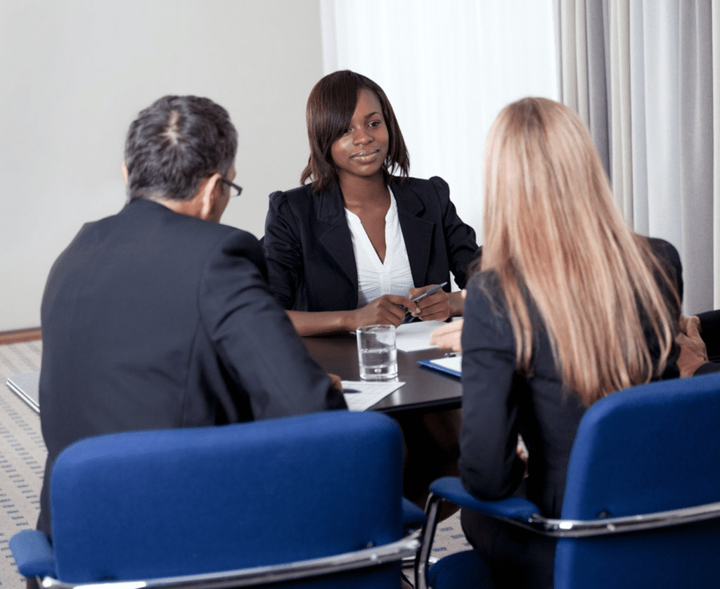 Three people on suits conducting a interviewer vs interviewee led case