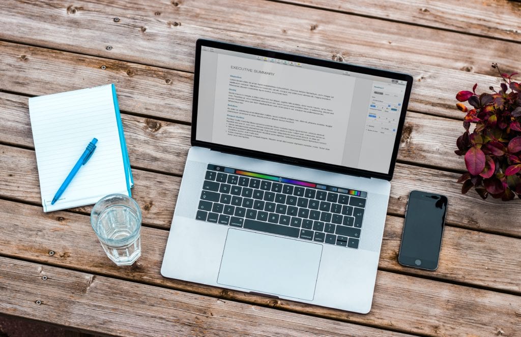 management consulting resume samples. Picture shows a laptop with a consulting resume up on the screen.