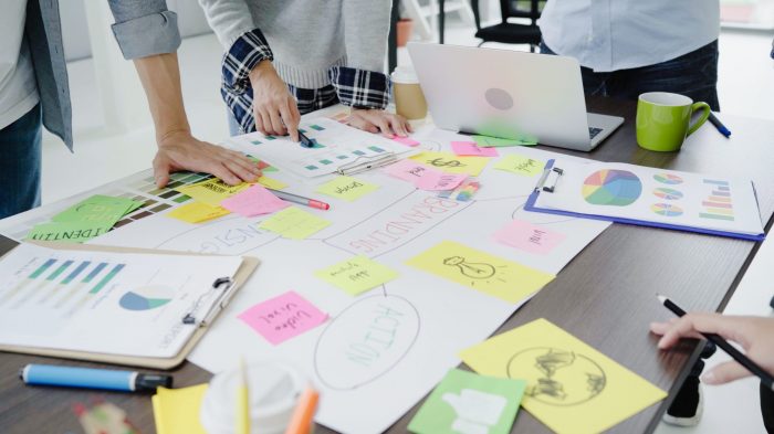 Group of casually dressed business people discussing ideas during consulting internships consulting internships examples of people brainstorming ideas