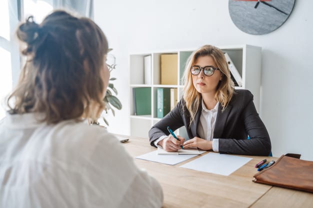 Consulting informational interview. this image shows two women discussing a business problem in an office.